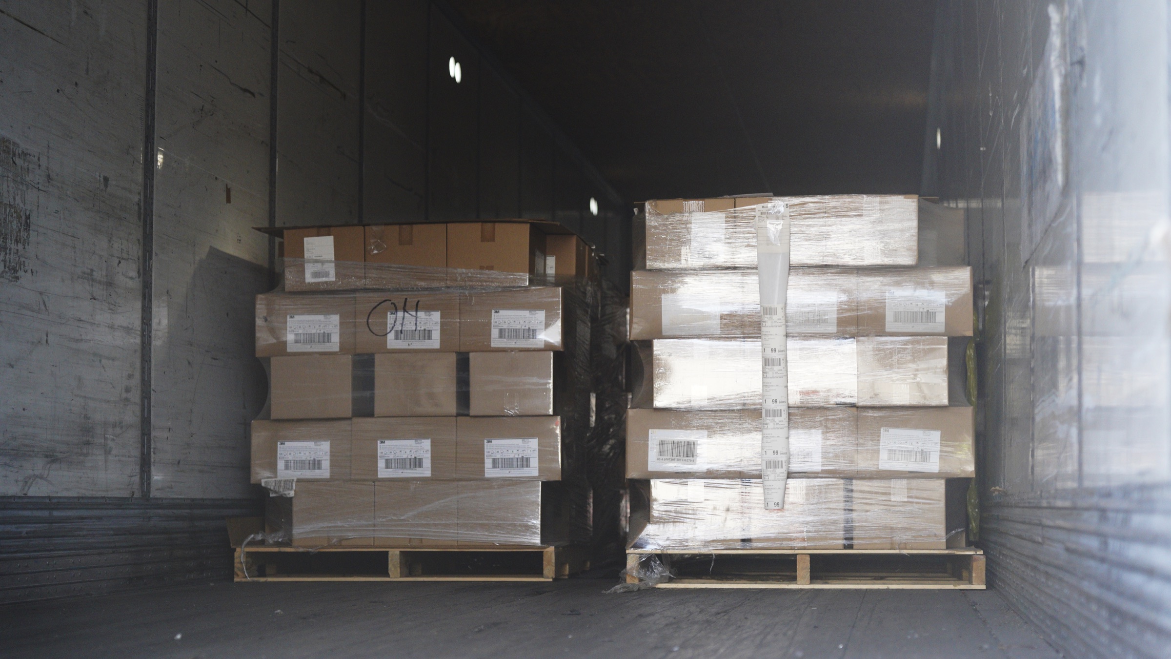 Pallets of boxed medical supplies inside the freight trailer